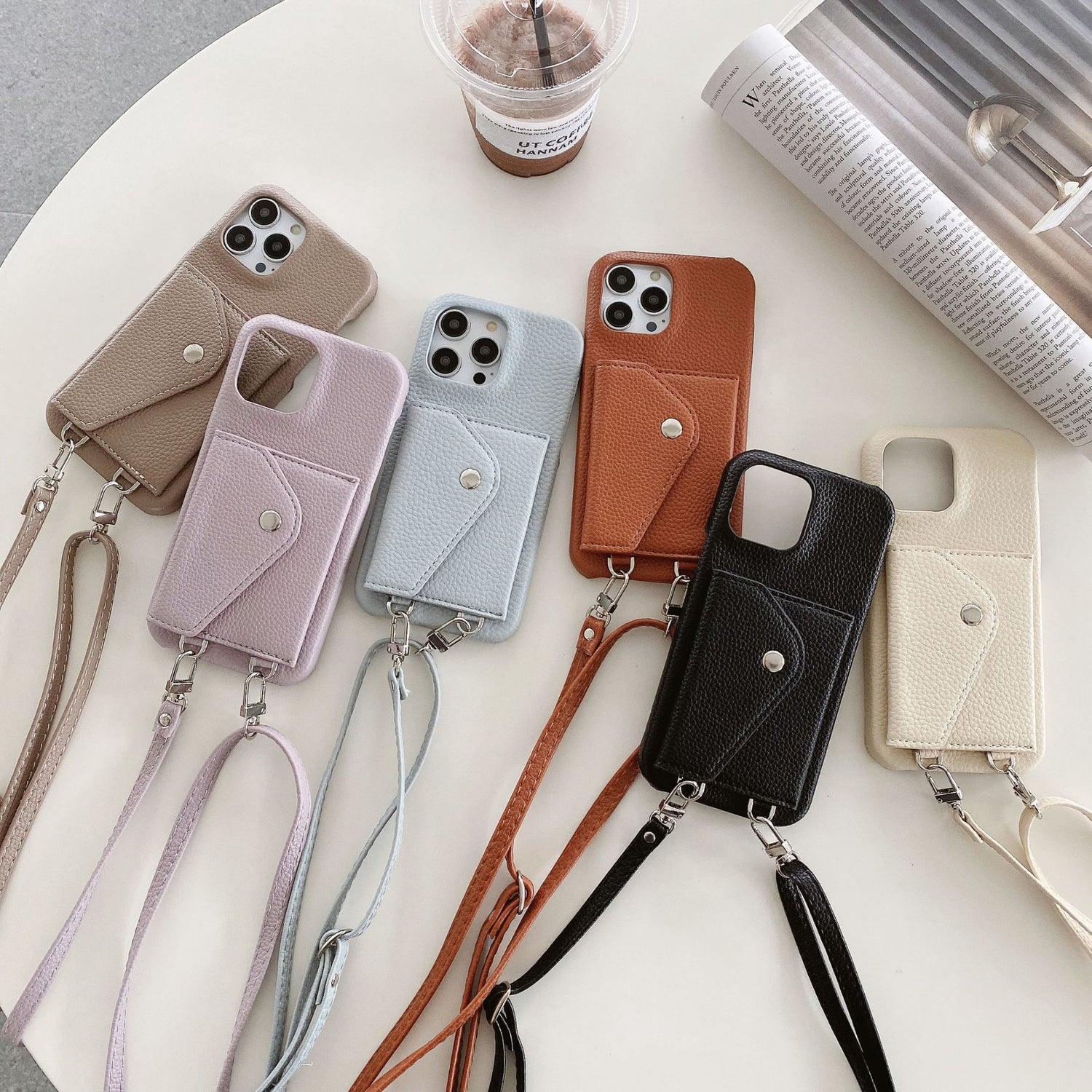 Collection of phone cases with straps on a white surface